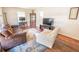 Cozy living room featuring hardwood floors, a plush sofa, and a large area rug at 1230 Hawthorne Cir, Hanahan, SC 29410