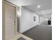 Well-lit hallway with neutral walls and carpet, unit door with number visible, and overhead lights at 125 Pier View St # 405, Daniel Island, SC 29492