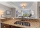 Bright kitchen with granite countertops and stainless steel sink overlooking the living room at 125 Pier View St # 405, Daniel Island, SC 29492