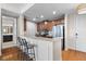 Open kitchen with stainless steel appliances and a breakfast bar with granite countertops at 125 Pier View St # 405, Daniel Island, SC 29492