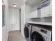 Convenient laundry room with a full-sized washer and dryer, shelving, and ample storage space at 125 Pier View St # 405, Daniel Island, SC 29492