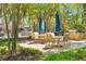 Inviting outdoor patio with tables, chairs, umbrellas, and a built-in grill, perfect for gatherings at 125 Pier View St # 405, Daniel Island, SC 29492