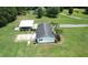 A beautiful single-Gathering home, featuring a detached garage, landscaped yard, and lush greenery from an aerial perspective at 131 Travis Hill Rd, Moncks Corner, SC 29461