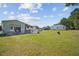 Expansive backyard featuring a well-maintained lawn, detached garage, covered patio, and an extra truck at 131 Travis Hill Rd, Moncks Corner, SC 29461
