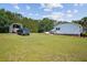Expansive backyard featuring a well-maintained lawn, truck parking, and the back of the home at 131 Travis Hill Rd, Moncks Corner, SC 29461