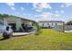 Wide backyard view showing a garage with covered patio, pool, green grass, and room to enjoy the outdoors at 131 Travis Hill Rd, Moncks Corner, SC 29461