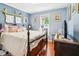 Cozy bedroom with a spindle bed, wood floors, and charming decor at 131 Travis Hill Rd, Moncks Corner, SC 29461