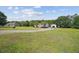 Charming single-story home featuring a sprawling green lawn, long driveway, and a detached garage at 131 Travis Hill Rd, Moncks Corner, SC 29461