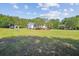 Charming single-story home featuring a sprawling green lawn and a detached garage and truck parking space at 131 Travis Hill Rd, Moncks Corner, SC 29461