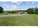 Charming single-story home featuring a sprawling green lawn, long driveway, and a detached garage at 131 Travis Hill Rd, Moncks Corner, SC 29461