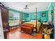 Cozy main bedroom with a four-poster bed, hardwood floors, and a large window at 131 Travis Hill Rd, Moncks Corner, SC 29461