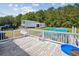 Elevated view of an above-ground pool and white railing, surrounded by trees and lush greenery, with garage nearby at 131 Travis Hill Rd, Moncks Corner, SC 29461