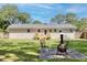 Expansive backyard featuring a brick house, patio, deck, lawn, and an outdoor seating area at 1317 White Dr, Charleston, SC 29407