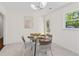 Cozy dining area with a glass table and woven chairs, complemented by natural light at 1317 White Dr, Charleston, SC 29407