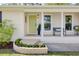 Inviting front porch featuring decorative plants, a stylish bench, and a cheerful yellow door at 1317 White Dr, Charleston, SC 29407