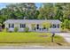 Charming one-story home with a well-manicured lawn and a classic brick exterior at 1317 White Dr, Charleston, SC 29407