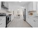 Modern kitchen with white cabinetry, stainless steel appliances, and tile flooring at 1317 White Dr, Charleston, SC 29407