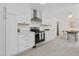 Bright kitchen features white cabinetry, stainless steel appliances, and stylish tile flooring at 1317 White Dr, Charleston, SC 29407