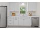 A close up of a kitchen with white cabinetry and stainless steel appliances at 1317 White Dr, Charleston, SC 29407