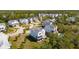 Aerial view of a charming neighborhood with lush greenery and beautifully designed homes, one with a pool at 1502 Menhaden Ln, Mount Pleasant, SC 29466