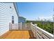 Balcony with wood floors and white rails with views of other homes and natural landscape at 1502 Menhaden Ln, Mount Pleasant, SC 29466