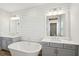 Bright bathroom with double vanities, soaking tub, shiplap accent wall and modern fixtures at 1502 Menhaden Ln, Mount Pleasant, SC 29466