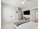 Neutral bedroom boasts a ceiling fan, tv, doorway and access to an ensuite bathroom at 1502 Menhaden Ln, Mount Pleasant, SC 29466