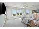 Bright bedroom with neutral carpet, ceiling fan, and large windows with natural views at 1502 Menhaden Ln, Mount Pleasant, SC 29466