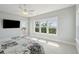 Bright bedroom with neutral carpet, ceiling fan, and large windows with natural views at 1502 Menhaden Ln, Mount Pleasant, SC 29466
