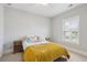 Cozy bedroom featuring a queen bed with a plush yellow quilt and side tables at 1502 Menhaden Ln, Mount Pleasant, SC 29466
