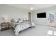 Bedroom featuring ceiling fan, TV, carpet and balcony door with natural light at 1502 Menhaden Ln, Mount Pleasant, SC 29466