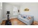 Bonus room features a blue sofa, workout bike and natural light from a window at 1502 Menhaden Ln, Mount Pleasant, SC 29466