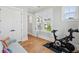 Bright bonus room features an exercise bike and a comfortable blue sofa with throw pillows at 1502 Menhaden Ln, Mount Pleasant, SC 29466