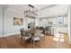 Dining area featuring a modern light fixture, hardwood floors, and seating for six at 1502 Menhaden Ln, Mount Pleasant, SC 29466