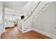 Open-concept entryway with hardwood flooring, a staircase, and a view of the bright living area at 1502 Menhaden Ln, Mount Pleasant, SC 29466