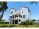 Charming two-story home showcasing a screened porch, multiple balconies, and beautiful exterior finishes at 1502 Menhaden Ln, Mount Pleasant, SC 29466