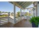 Inviting front porch with wood flooring, white railings, and comfortable seating, perfect for relaxing outdoors at 1502 Menhaden Ln, Mount Pleasant, SC 29466