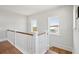 Hallway with wooden banister and shiplap detail on wall leading to stairs at 1502 Menhaden Ln, Mount Pleasant, SC 29466