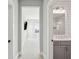 Hallway view showing bathroom with shiplap and bedroom with carpet, paint in neutral colors at 1502 Menhaden Ln, Mount Pleasant, SC 29466