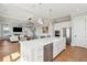 Open kitchen with white cabinets, a large island, and a view into the living area at 1502 Menhaden Ln, Mount Pleasant, SC 29466