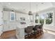 Bright kitchen with white cabinets, a center island with seating, and natural light at 1502 Menhaden Ln, Mount Pleasant, SC 29466