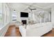 Open living room featuring a fireplace, large windows, and a staircase at 1502 Menhaden Ln, Mount Pleasant, SC 29466