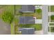 Aerial view of home showcases solar panels, well-maintained lawn, and proximity to pond at 151 Tyger St, Summerville, SC 29485