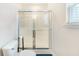 Bright bathroom features a shower and toilet with tiled floors near the window at 151 Tyger St, Summerville, SC 29485