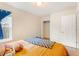 Bright bedroom boasts wood floors, walk in closet, and a window with blue curtains at 151 Tyger St, Summerville, SC 29485