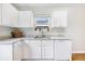 Well-lit kitchen featuring white cabinets, granite countertops, and a stainless steel sink at 151 Tyger St, Summerville, SC 29485