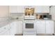 Modern white kitchen featuring granite countertops, stainless appliances, and ample cabinet space at 151 Tyger St, Summerville, SC 29485