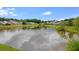 Picturesque view of the homes surrounding the pond, reflecting the blue sky and lush greenery at 151 Tyger St, Summerville, SC 29485