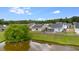 Aerial view of homes backing onto the pond, featuring well-maintained lawns at 151 Tyger St, Summerville, SC 29485