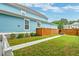 Fenced backyard with green grass and a concrete walkway at 1511 Hopkins Ln, Mount Pleasant, SC 29466